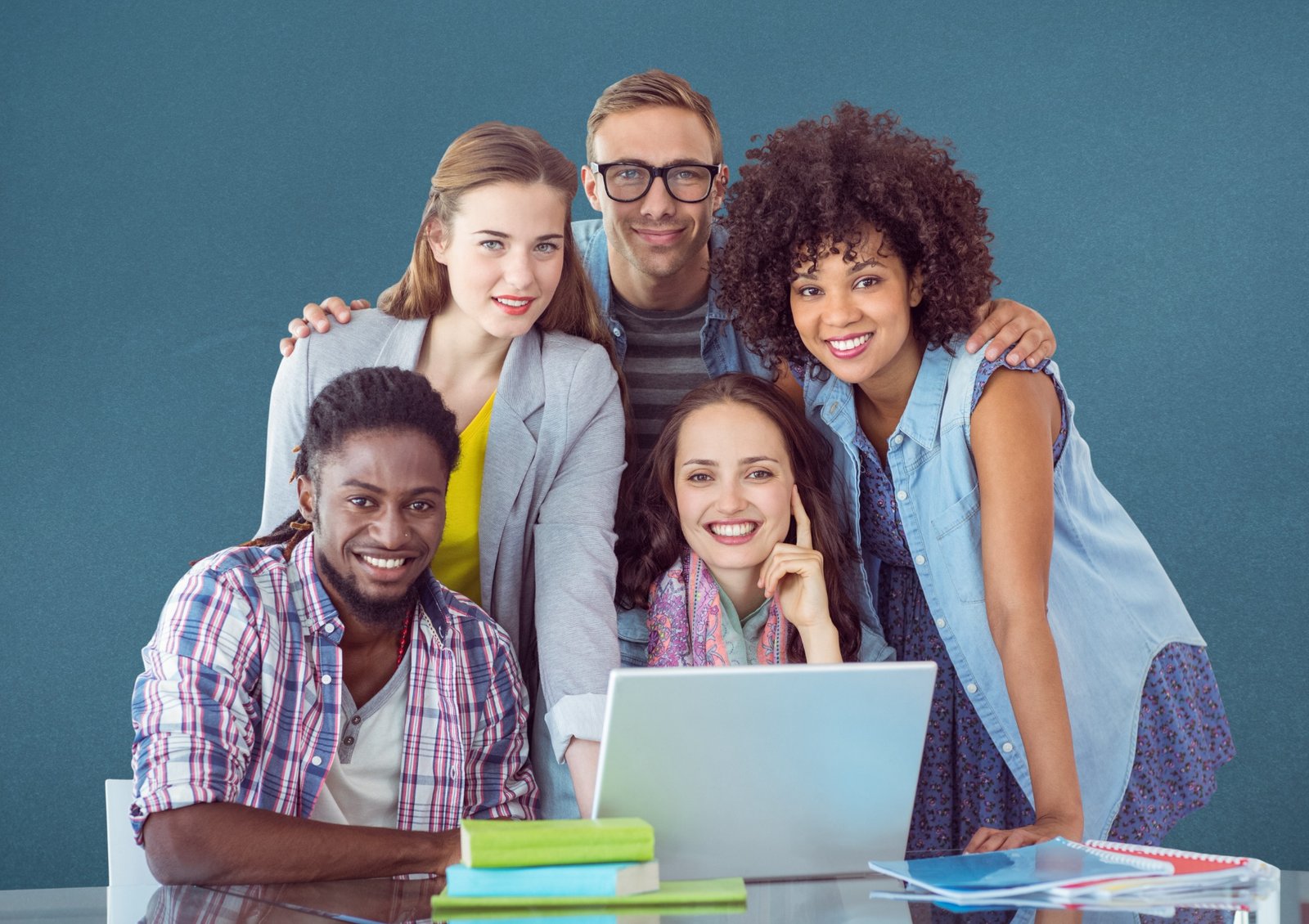 Students gathered around a laptop